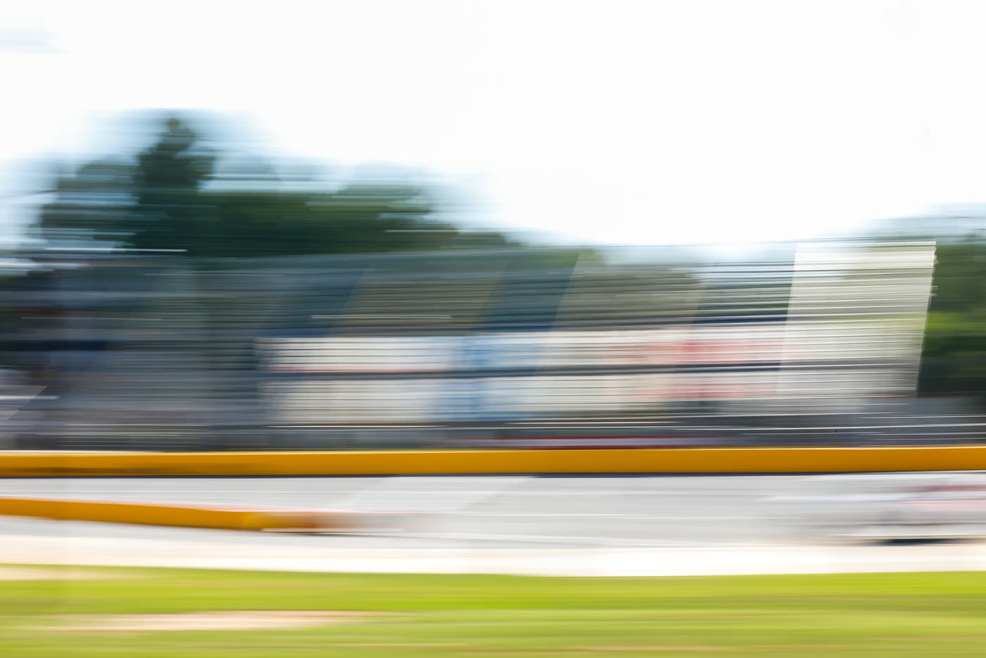 Panned shot of a late model running the bottom groove
