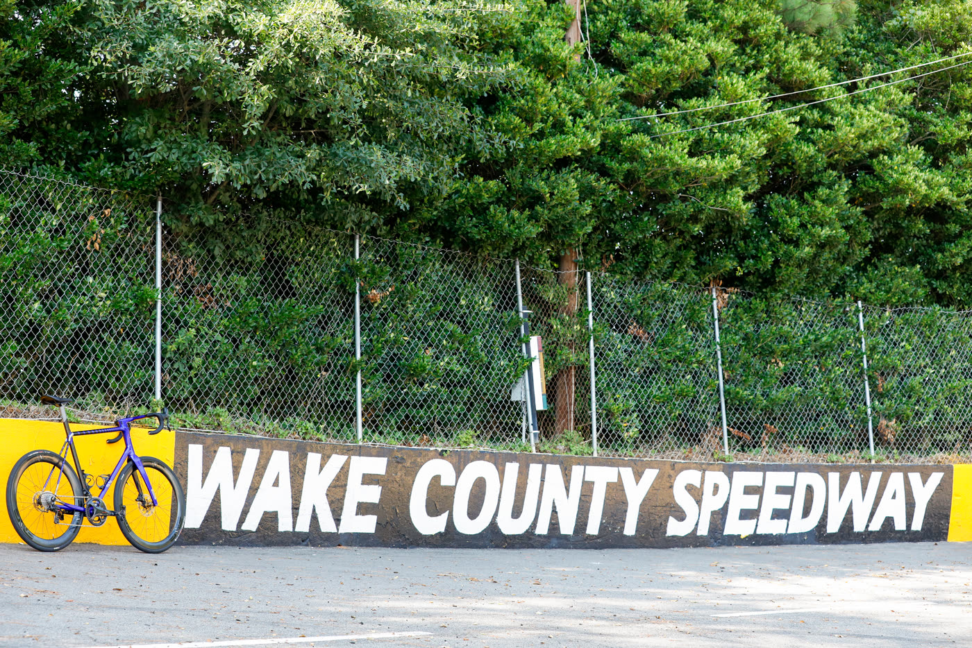 The 427 parked under the Wake County Speedway wall sign