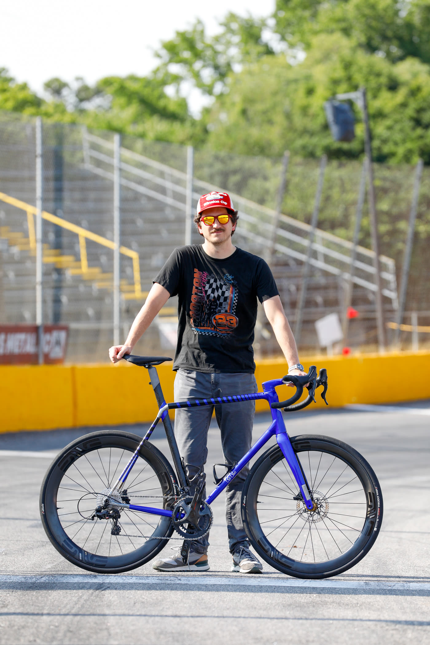 Dustin standing with the finished 427 on the front stretch - builder portrait