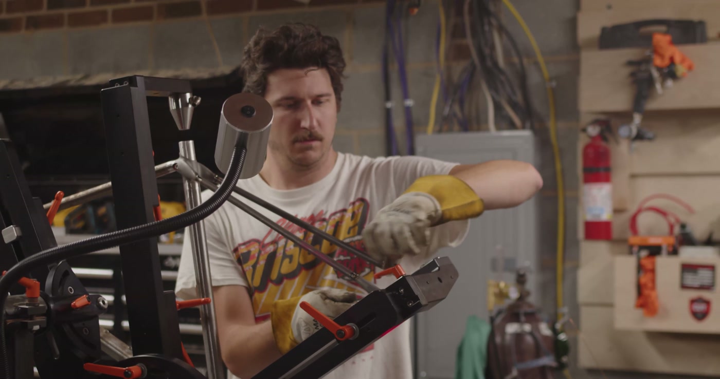 Working the frame in the jig — welding gloves on