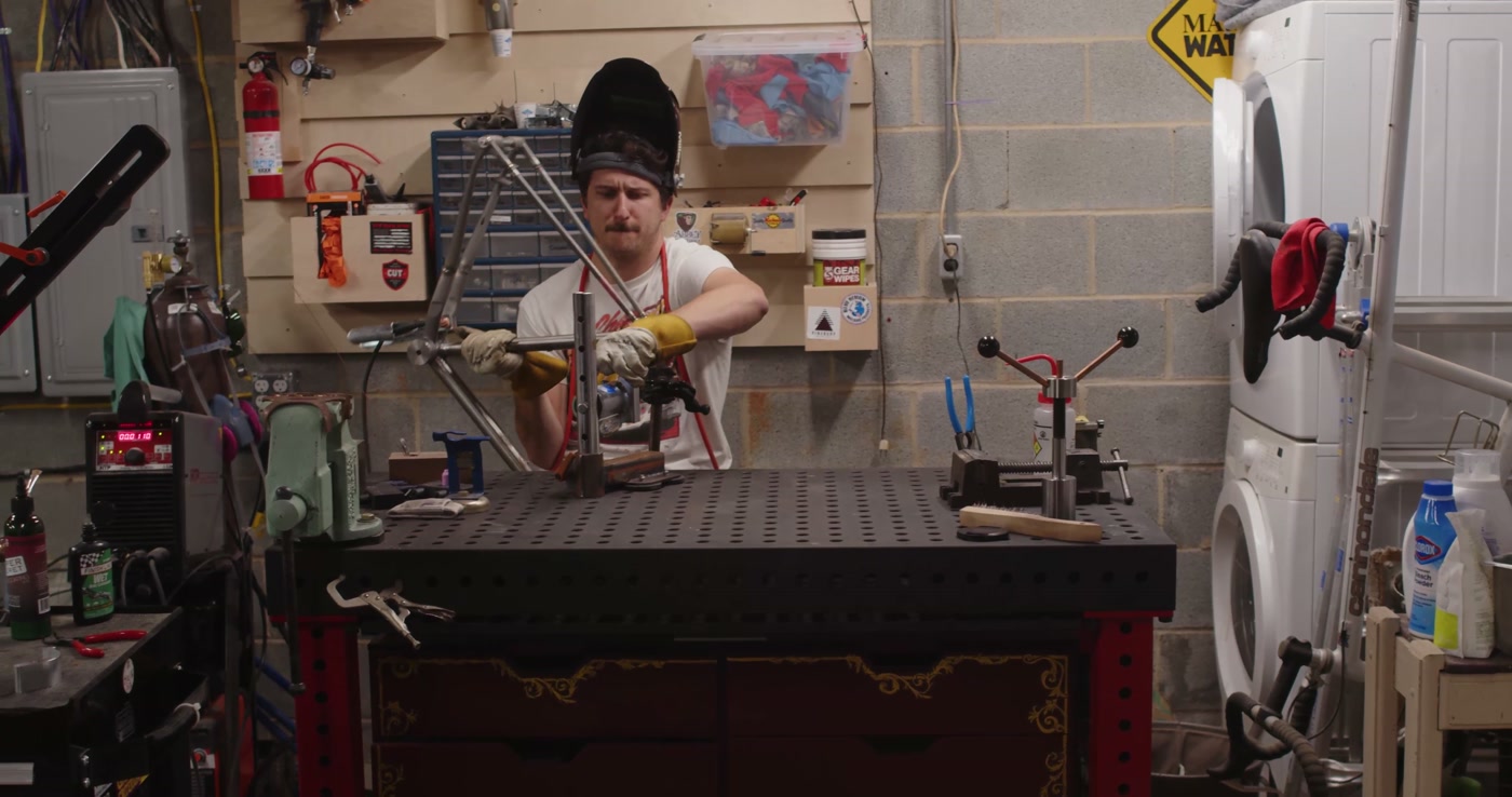 The shop — Dustin at the welding table with tools laid out