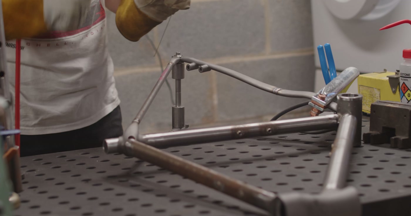 Raw steel frame laid out on the welding table